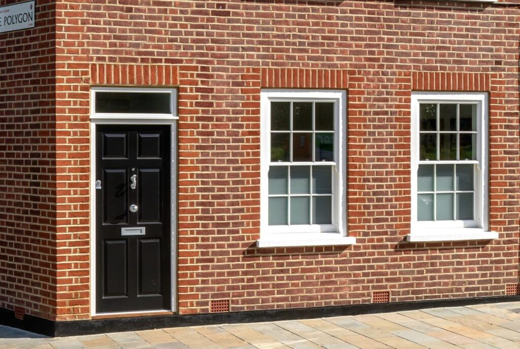 black timber front door on red brick house